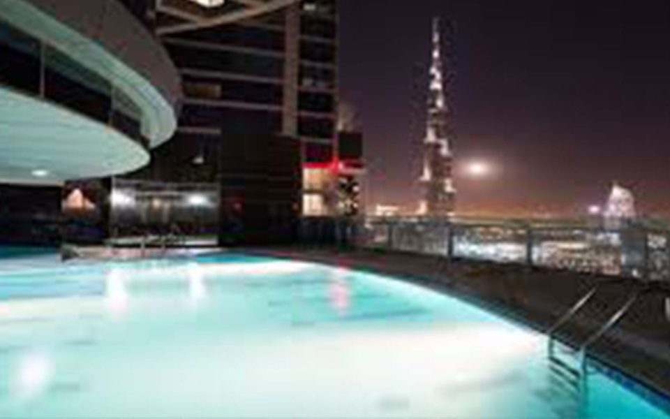 Swimming Pool and Poolside Amenities at Falcon Tower for Ready-to-Move-in Apartments in Dubai with Amlakuae Group
